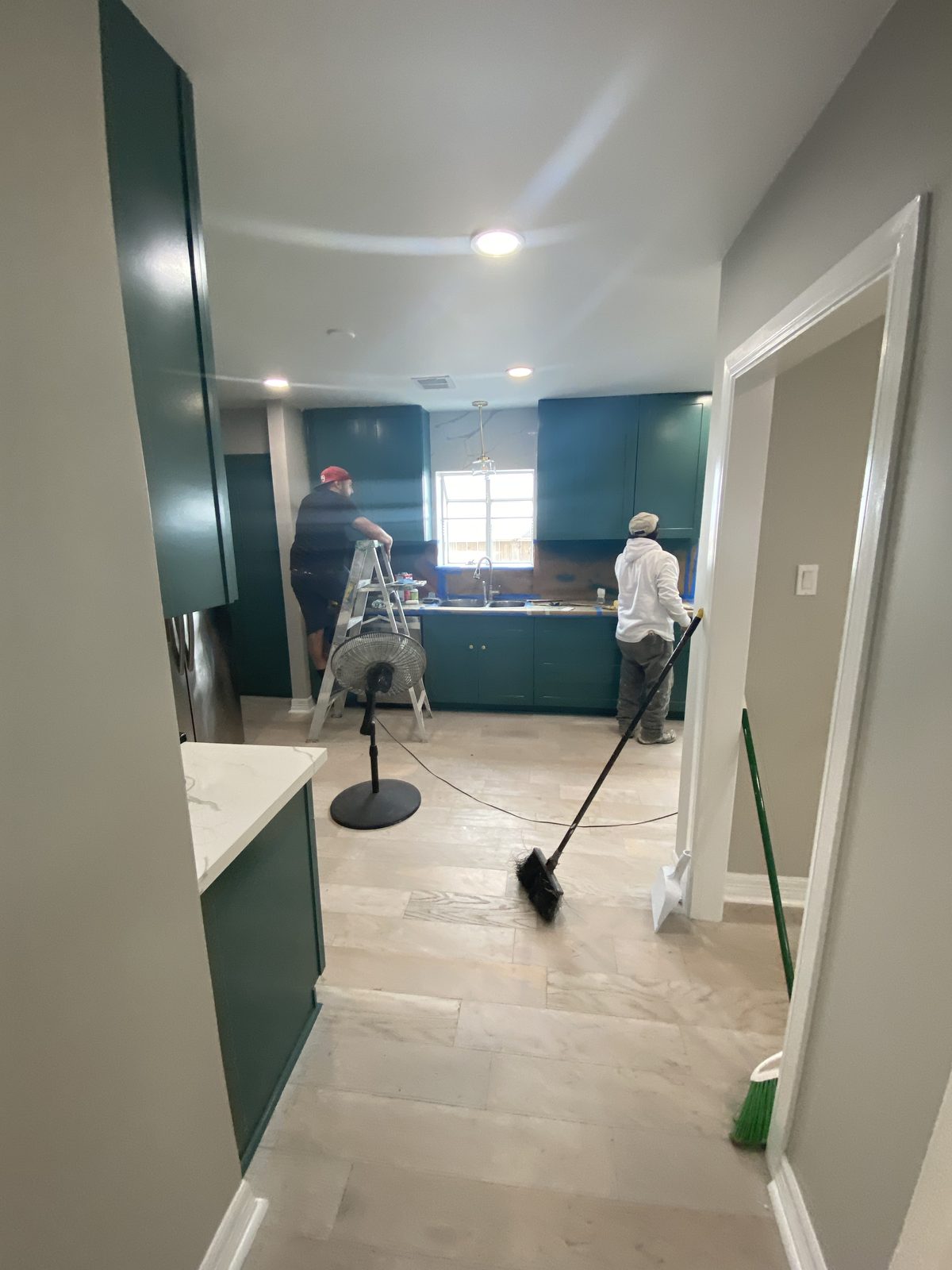 A&C Painting and Remodeling crew completing cabinet and interior painting work